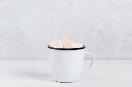 White mug of hot cocoa with marshmallow, light backgroundの写真素材