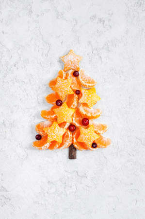 Christmas tree made of mandarines, festive compositionの写真素材