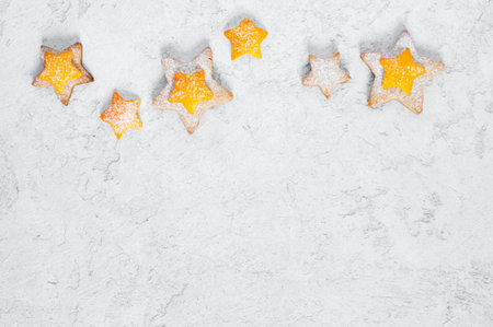 White winter textured background with orange cookies, copy space