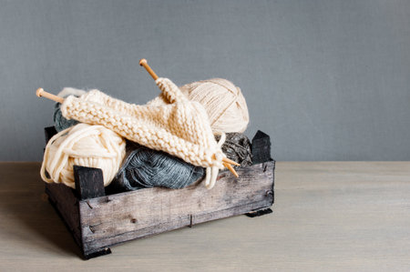 Knitting in the wooden box on the table