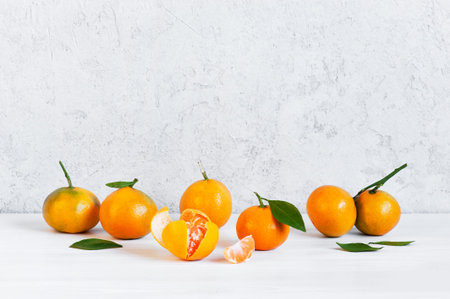 Background with fresh ripe tangerines on the white table
