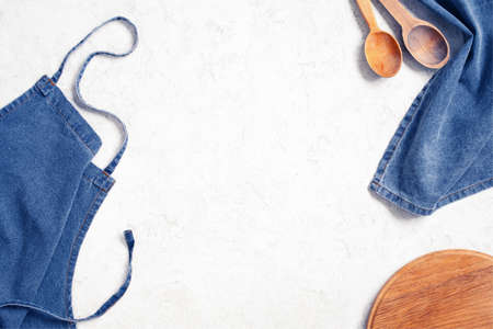 Vintage light kitchen background with denim napkin and silver dishes, copy spaceの写真素材