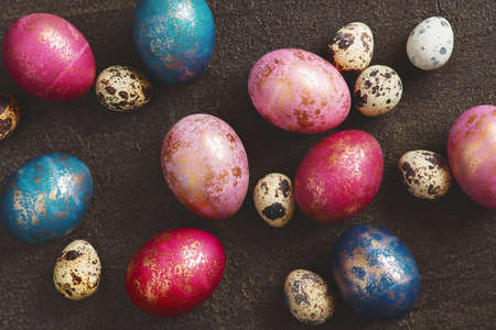 Pattern of painted colorful Easter eggs with golden spots, top viewの写真素材