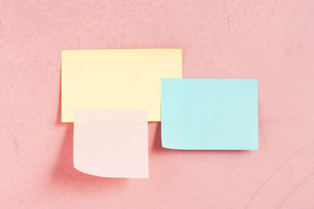 Three various paper sticks on the pink-coral textured wall, copy spaceの写真素材