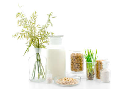 Various products of oat in the medical bottles on white, concept of organic foodの写真素材