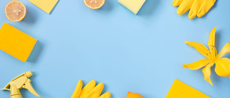Blue banner with cleaning supplies and lemons, bright background with copy space