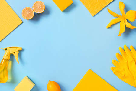 Blue background with cleaning supplies and lemons, bright background with copy spaceの写真素材
