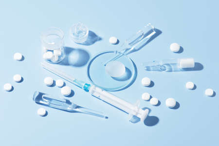 Pharmaceutical drugs on the blue background, concept of complex treatmentの写真素材