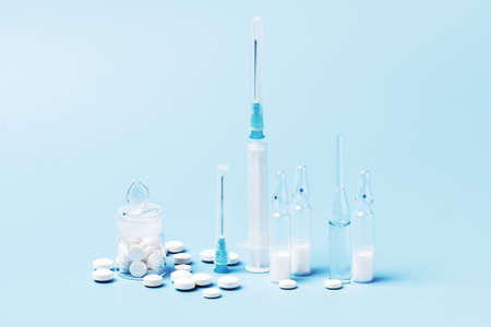 Pharmaceutical drugs on the blue background, concept of complex treatmentの写真素材