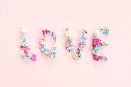 The word Love made of fresh flowers, tender pink compositionの写真素材