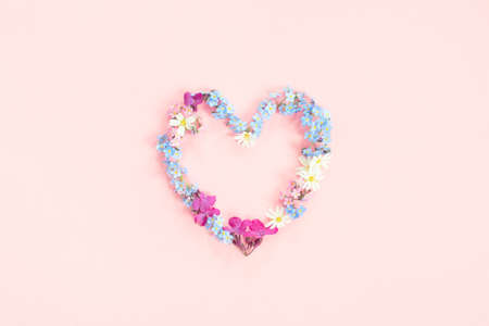 Heart shape made of fresh flowers, tender pink compositionの写真素材