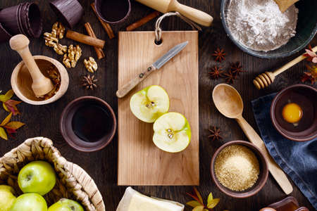 Ingredients for traditional apple pie on the textured brown wooden table, top viewの写真素材