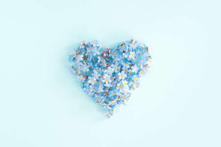 Heart of blue fresh flowers, top view conceptual cardの写真素材