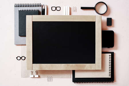 Education supplies and chalkboard on the textured beige table, overhead viewの写真素材