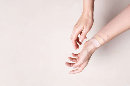 Female hands with smears of beige facial foundation, color testの写真素材