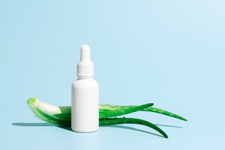 Aloe fresh serum, leaves of aloe and dropper on blueの写真素材