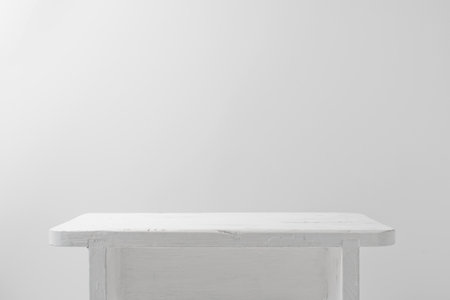 Minimalistic white background with small table, podium with copy spaceの写真素材