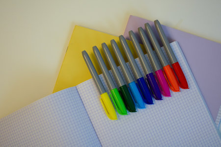 multi-colored felt-tip pens for drawing on the background of an empty notebook and pensの写真素材