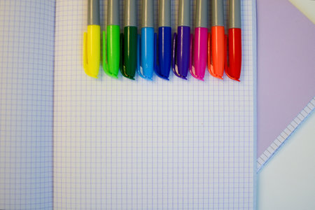 multi-colored felt-tip pens for drawing on the background of an empty notebook and pensの写真素材