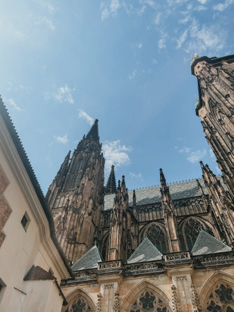 view of St. Vitus Cathedral and square nearby on a sunny day in the Czech city of Pragueの写真素材