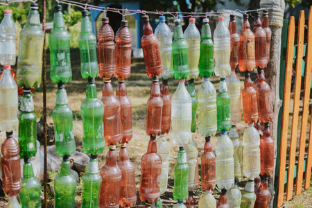 A way to reuse plastic with benefits in the form of a bottle fence while protecting the environmentの写真素材