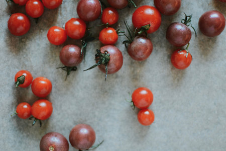 juicy red whole cherry tomatoes for cooking on a brown background