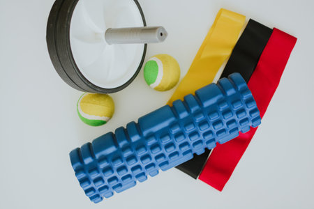 sports equipment such as a roller for relaxing, tennis balls and an elastic band for stretchingの写真素材