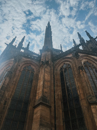 view of St. Vitus Cathedral and square nearby on a sunny day in the Czech city of Pragueの写真素材