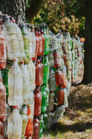 way to reuse plastic with benefits in the form of a bottle fence while protecting the environmentの写真素材