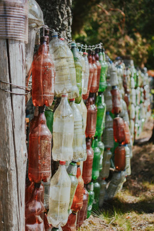 way to reuse plastic with benefits in the form of a bottle fence while protecting the environmentの写真素材
