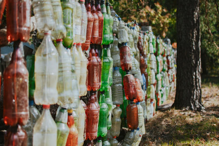 A way to reuse plastic with benefits in the form of a bottle fence while protecting the environmentの写真素材