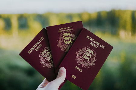 three red passports for travel against a background of natureの写真素材