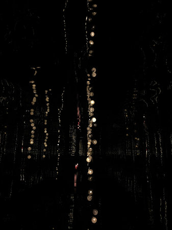 garlands with lanterns hanging from the ceiling on a backdrop of a black mirror background