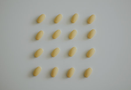 smoothly aligned yellow tablets on a white backgroundの写真素材