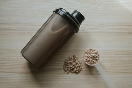 measuring cup with chocolate protein and shake for making a cocktailの写真素材