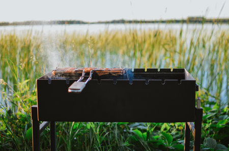 grill with hot coals for cooking grilled meat on the lake on a summer dayの写真素材