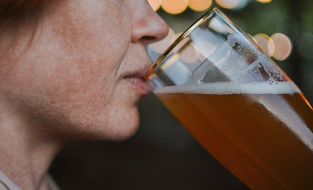 woman drinks dark refreshing beerの写真素材