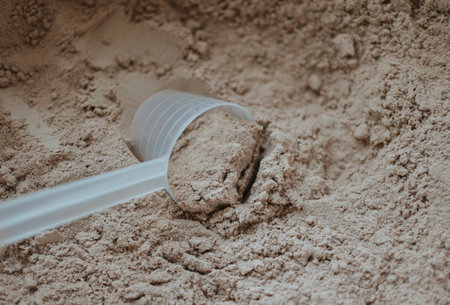 measuring cup with chocolate protein for training athleteの写真素材