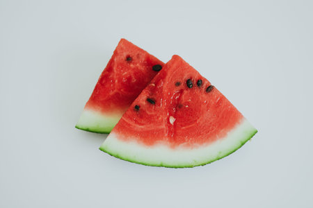 slices of juicy red watermelon with black seeds on a hot summer day