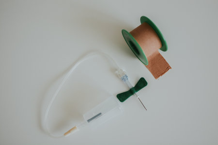 butterfly needle for drawing blood and medical tape for a medical worker with a white backgroundの写真素材