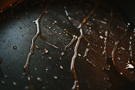 exposure of chaotically located and flowing drops on a black background with lightの写真素材