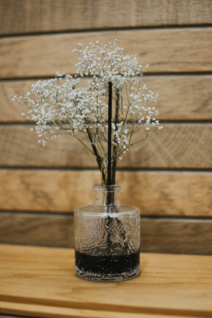 diffuser with flowers for beauty and smell on a background of wooden tilesの写真素材