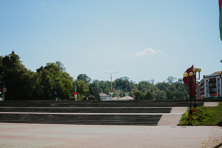 red and green flags hanging on pole in the sky on a center squareの写真素材