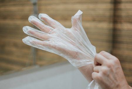 woman puts gloves on her handの写真素材