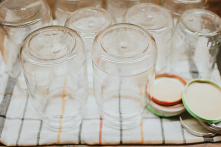 jars with lids for seaming with tomatoes and cucumbers for the winter standing on a towel