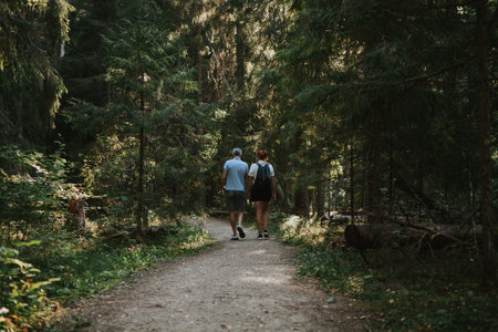 people are hiking together along a path deep in the forest: Taevaskoja, Estonia, September 7の写真素材