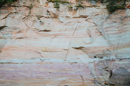 Beautiful sandstone cliffs and caves in Southern Estonia on a summer dayの写真素材