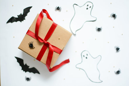 halloween gift box with ghosts, spiders, cobwebs, bats on a white background for celebrating