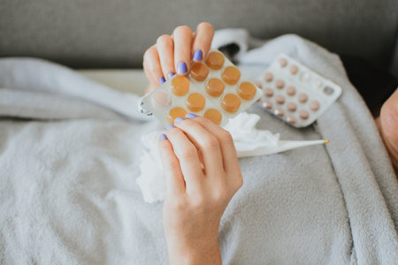 a woman wrapped in a scarf holds a lot of pills for illness against the background of medicines