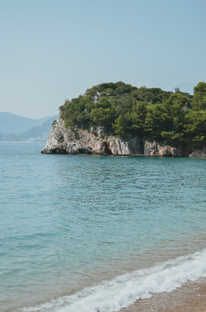 view from a private beach of rocks with trees and the Adriatic Sea in Montenegroの写真素材